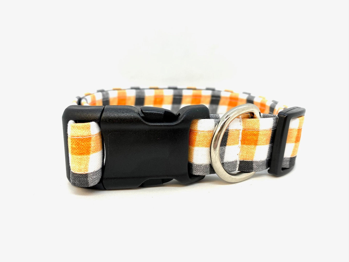 Halloween dog collar with orange, black, and white checkered pattern on a white background