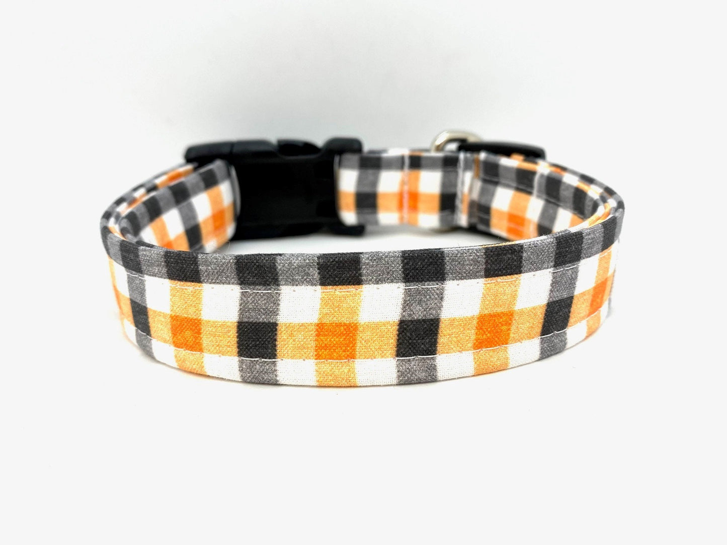 Plaid Halloween dog collar with black, orange, and white pattern on a white background