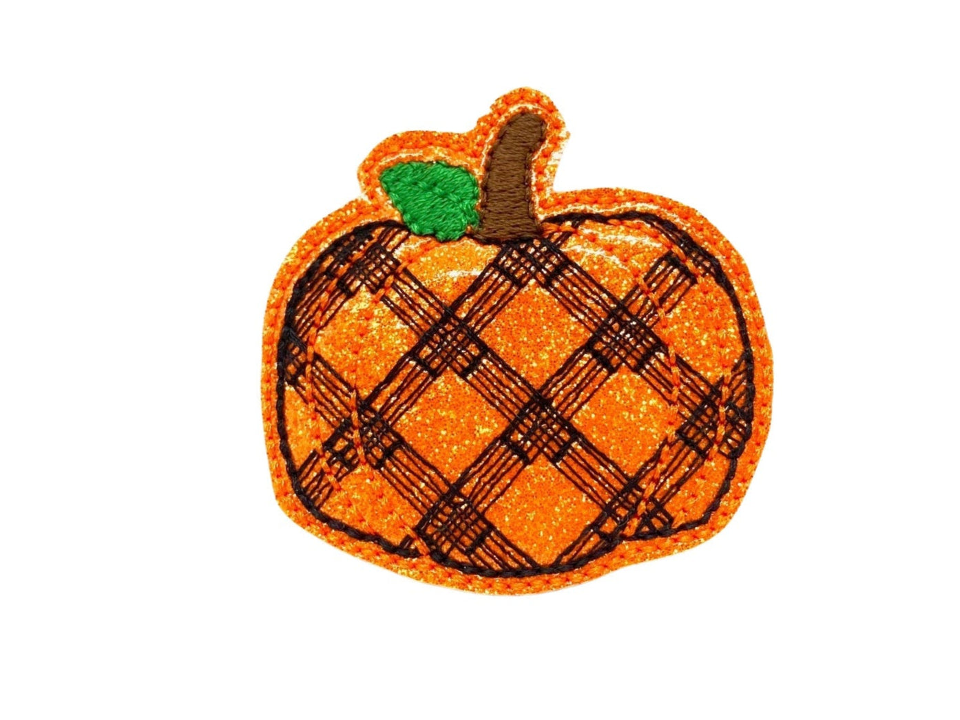 Handmade patchwork pumpkin dog collar embellishment in orange and plaid tones, attached to a collar with an elastic loop.