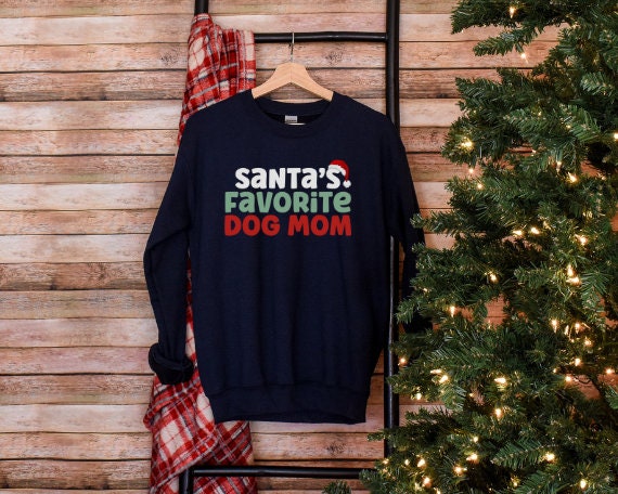 Navy “Santa’s Favorite Dog Mom” sweatshirt with festive red and green holiday lettering, cozy unisex fit, and perfect for Christmas-loving dog moms.