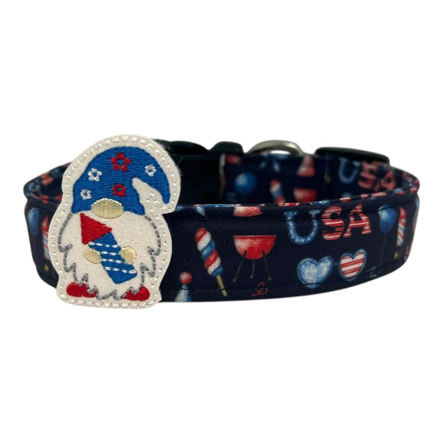 Navy blue 4th of July dog collar decorated with red, white, and blue icons like popsicles, BBQ grills, fireworks, and balloons, featuring a whimsical gnome holding a firecracker embellishment.