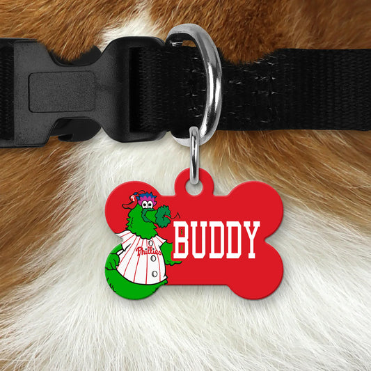 Red bone-shaped dog tag featuring the Phillie Phanatic mascot and the name "Buddy," attached to a black dog collar.