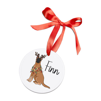 Personalized Belgian Malinois Christmas ornament featuring a festive illustration of a Malinois wrapped in holiday lights and reindeer antlers, made from glossy acrylic with a red hanging ribbon.