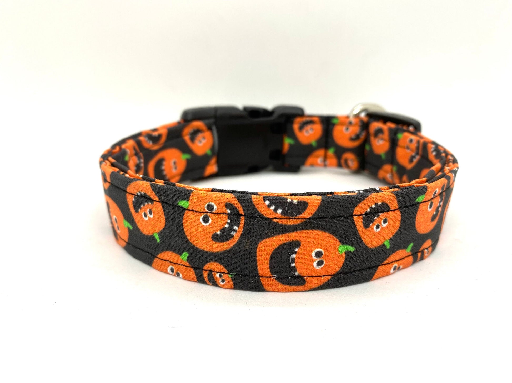 Dog collar with Halloween-themed pumpkin design on a white background