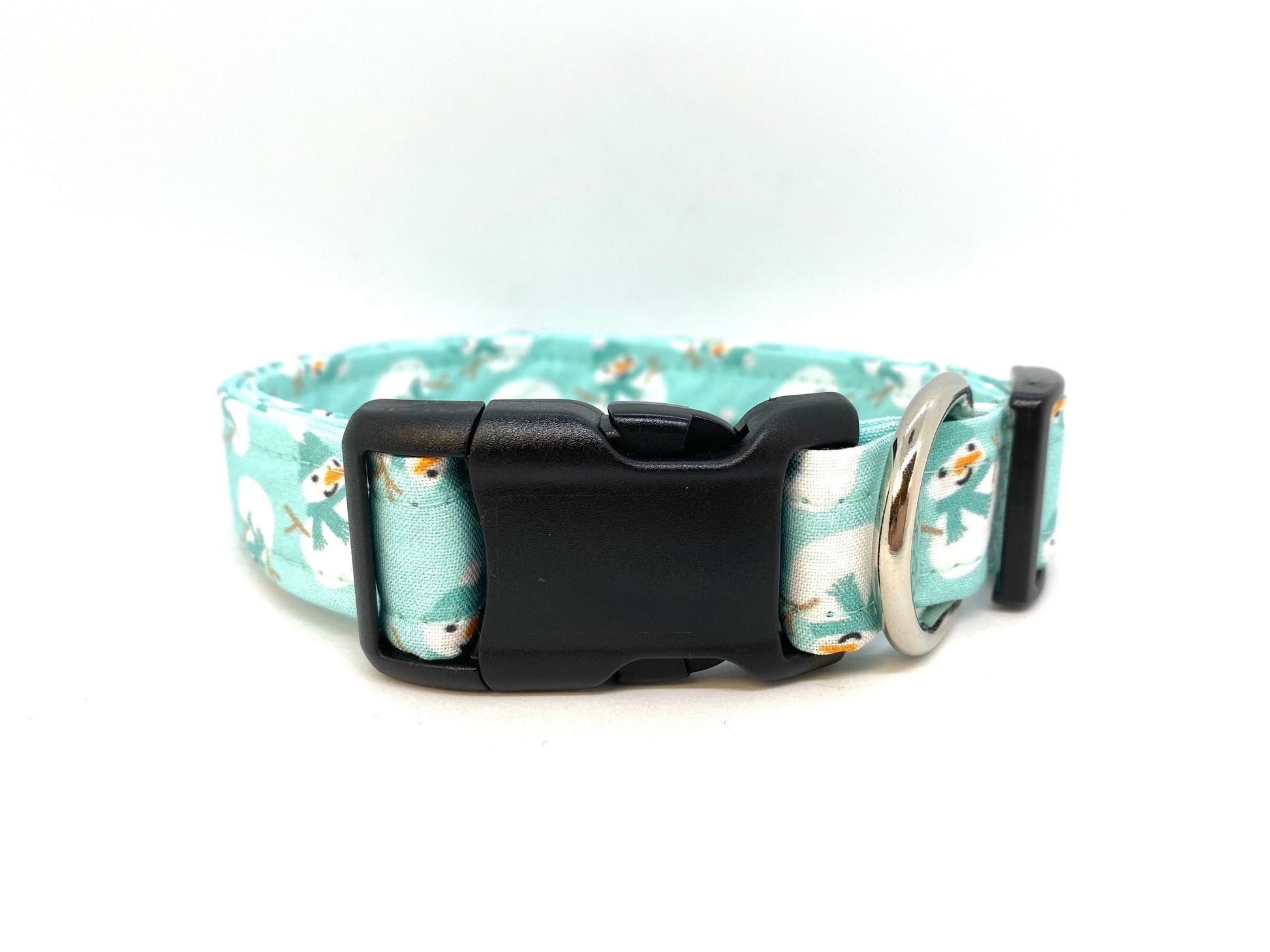 Light blue aqua dog collar decorated with scattered snowmen wearing aqua blue scarves, shown flat to highlight the festive winter pattern.