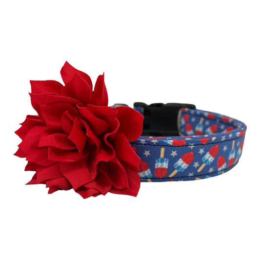 Patriotic popsicle-themed dog collar with red, white, and blue design, paired with a detachable red flower accessory