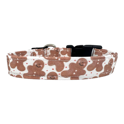 White dog collar with scattered gingerbread men pattern, festive Christmas design, handmade holiday pet accessory.