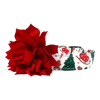 Festive dog collar featuring a pattern of Christmas trees, sleds, and gingerbread cookies, shown with a 3-inch red flower embellishment attached by an elastic loop.