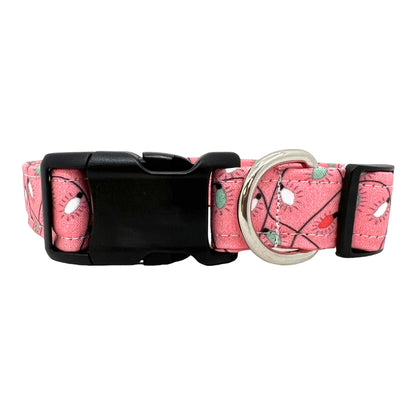 Pink dog collar decorated with a colorful string of Christmas lights, shown flat to highlight the festive holiday design.