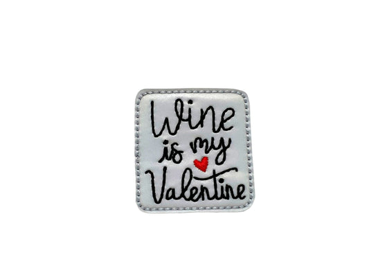Silver square dog collar embellishment with “wine is my valentine” text attached with elastic loop