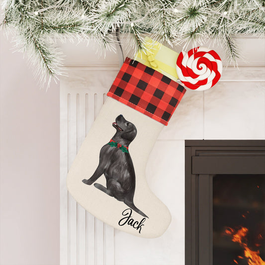 Cream-colored burlap dog Christmas stocking with watercolor black Labrador design, personalized with dog’s name, plaid cuff, and jingle bell collar.