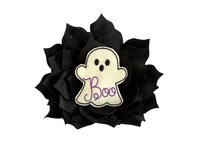 Black dog collar flower with a shimmery white ghost label saying 'Boo' on a white background