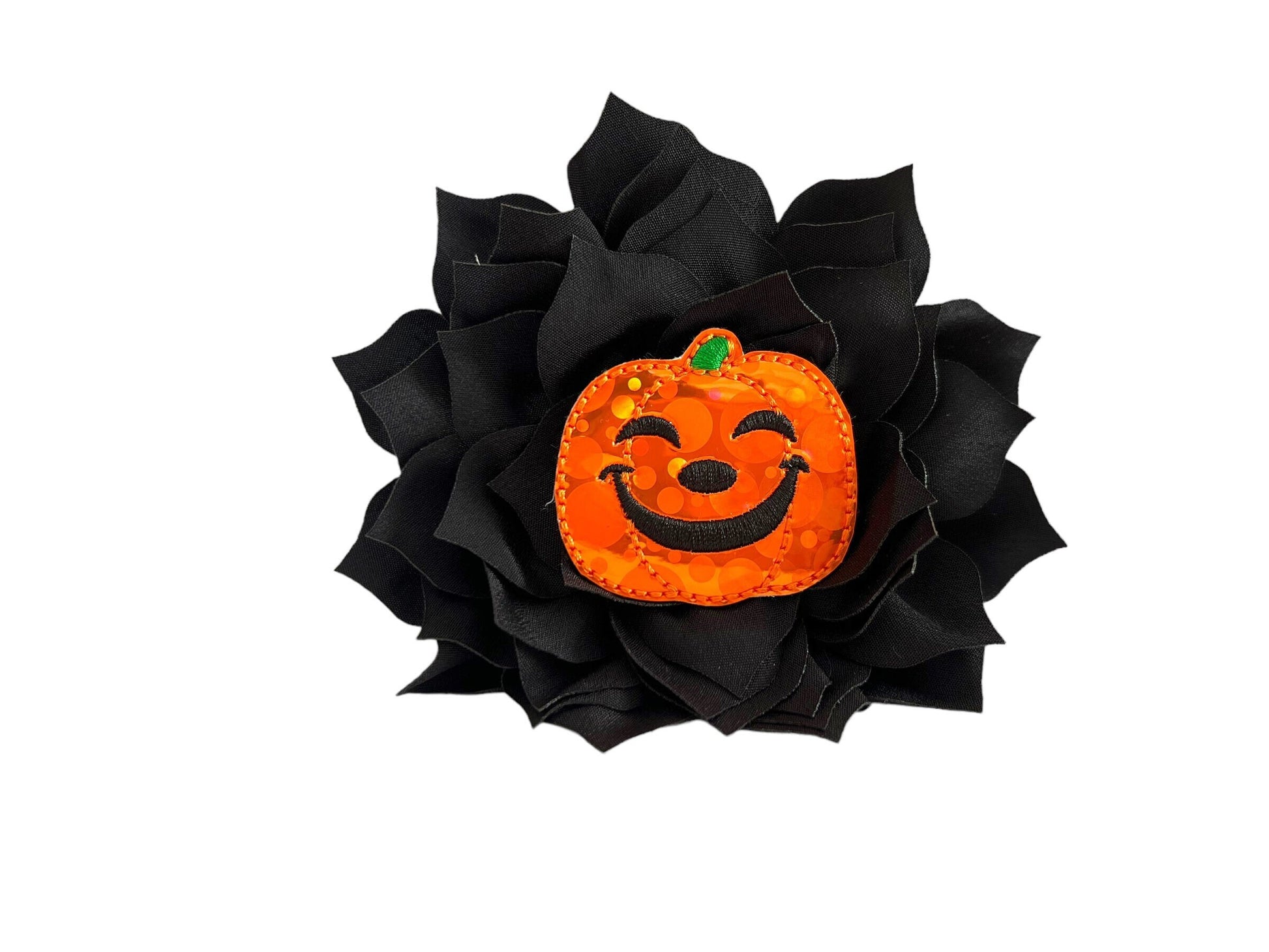 Orange jack-o’-lantern dog collar flower with layered petals, shown with elastic loop for easy collar attachment.
