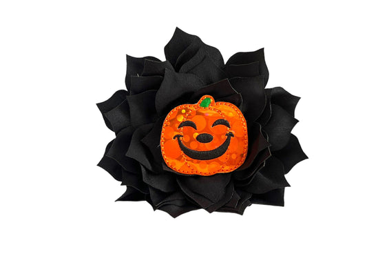 Orange jack-o’-lantern dog collar flower with layered petals, shown with elastic loop for easy collar attachment.
