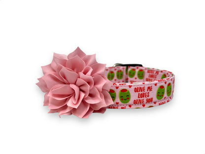 Light pink Valentine’s Day dog collar with heart-shaped olive pattern, “Olive Me, Loves Olive You” text, and removable light pink flower embellishment.