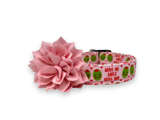 Light pink Valentine’s Day dog collar with heart-shaped olive pattern, “Olive Me, Loves Olive You” text, and removable light pink flower embellishment.