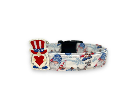 Patriotic dog collar featuring nautical gnomes in red, white, and blue attire, accented with a removable gnome embellishment attached by an elastic loop.