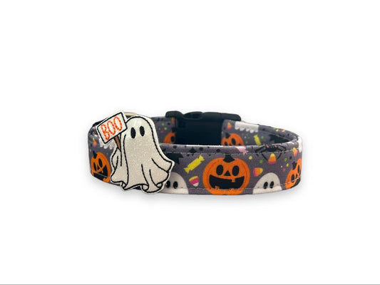 Gray Halloween dog collar with colorful ghosts, pumpkins, spiders, witch hats, candy, and a detachable ghost embellishment.
