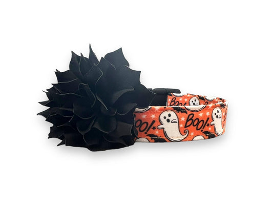 Orange Halloween dog collar with playful ghosts, black bats, “Boo!” text, and a detachable black flower embellishment.
