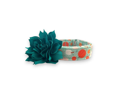 Brighten up spooky season with this aqua Halloween dog collar featuring pink, white, and orange pumpkins. Includes a removable 3" or 4" flower in your choice of color.
