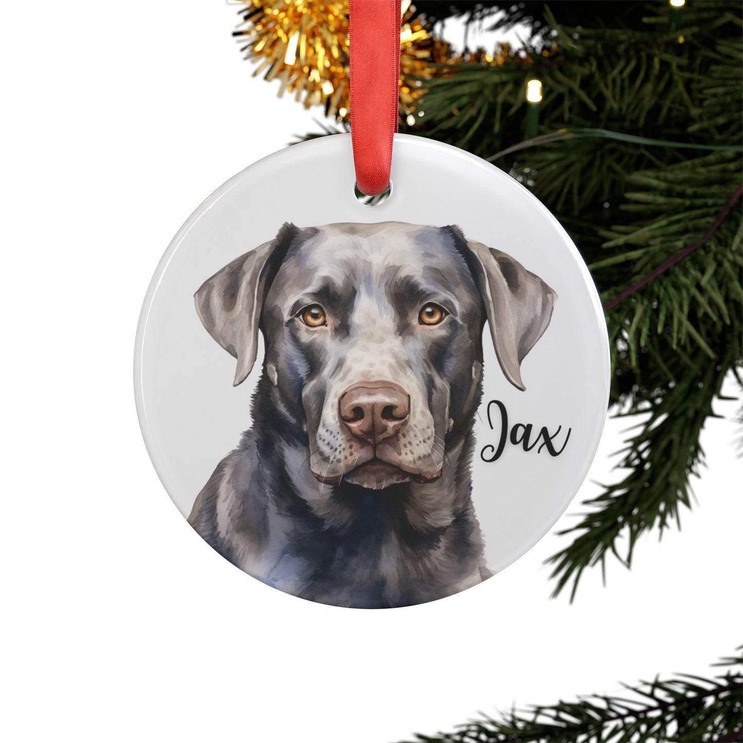 Round acrylic Christmas ornament featuring a watercolor silver Labrador, personalized with the dog’s name and finished with a red ribbon for hanging.