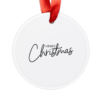 Back of round acrylic Christmas ornament featuring a Merry Christmas design and red ribbon for hanging.
