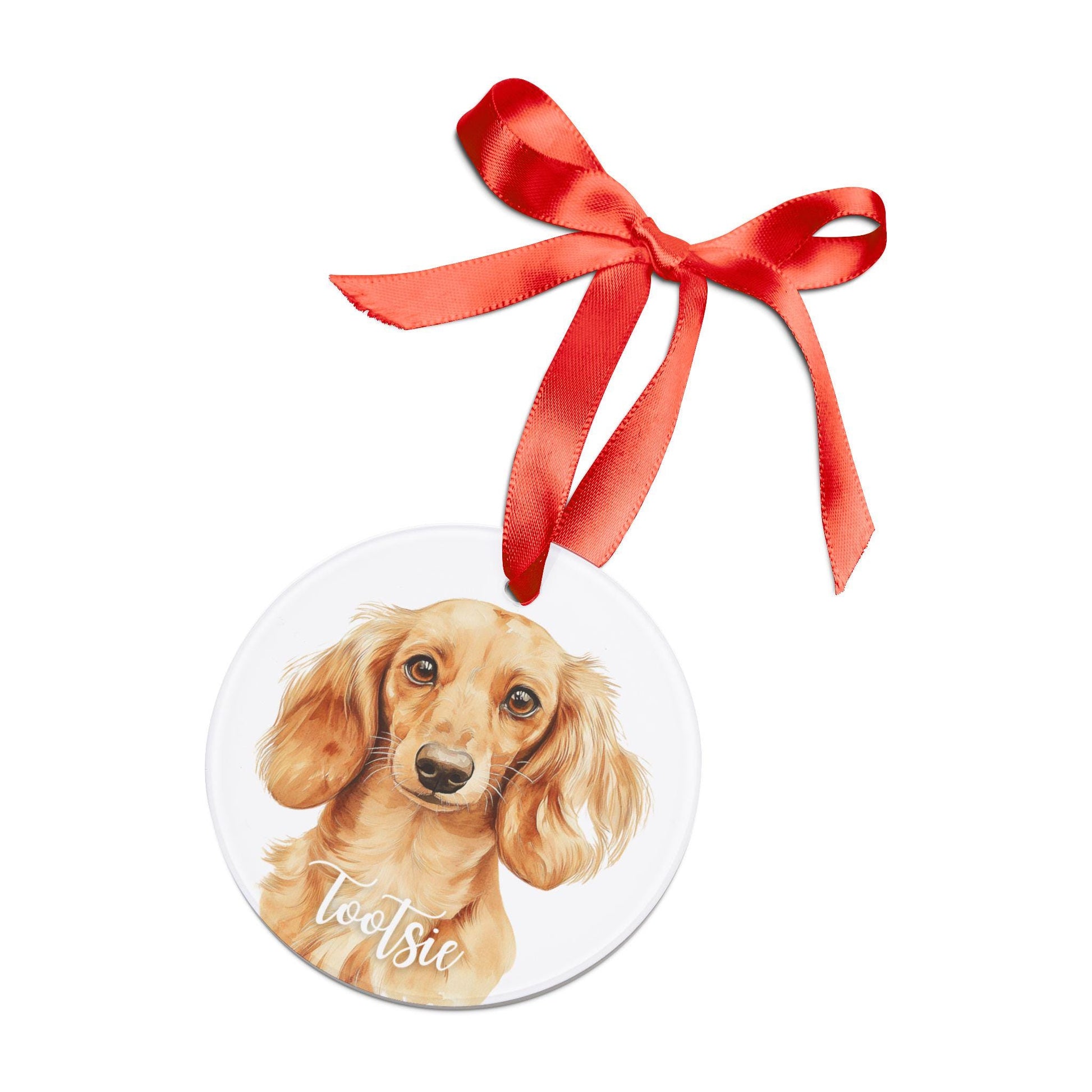 Round acrylic Christmas ornament featuring a watercolor Long Haired Cream Dachshund, personalized with the dog’s name and finished with a red ribbon for hanging.