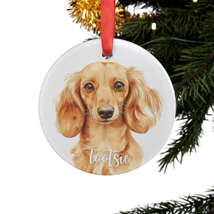 Round acrylic Christmas ornament featuring a watercolor Long Haired Cream Dachshund, personalized with the dog’s name and finished with a red ribbon for hanging.