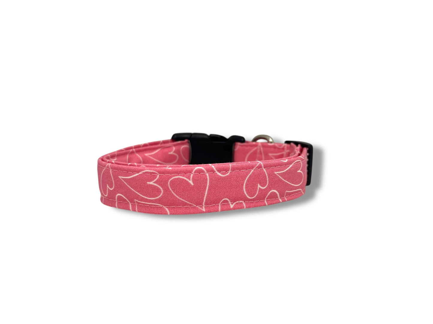 Bright pink dog collar with white heart outline design, Valentine’s Day themed dog collar shown flat and ready to wear.
