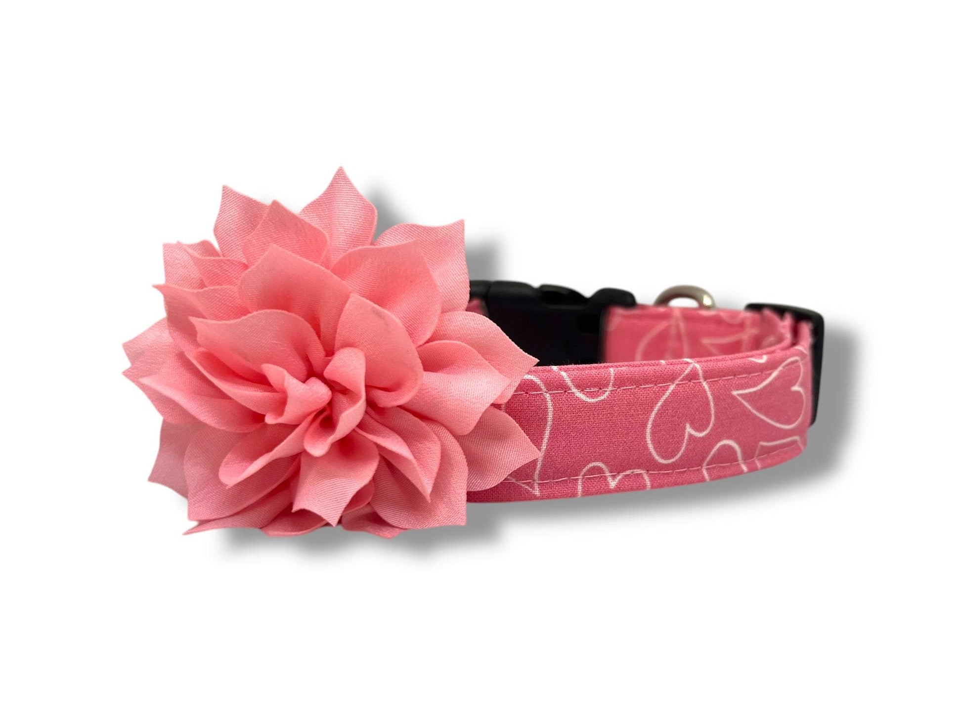 Bright pink dog collar with white heart outline design, and removable light pink dog collar flower for Valentine’s Day.