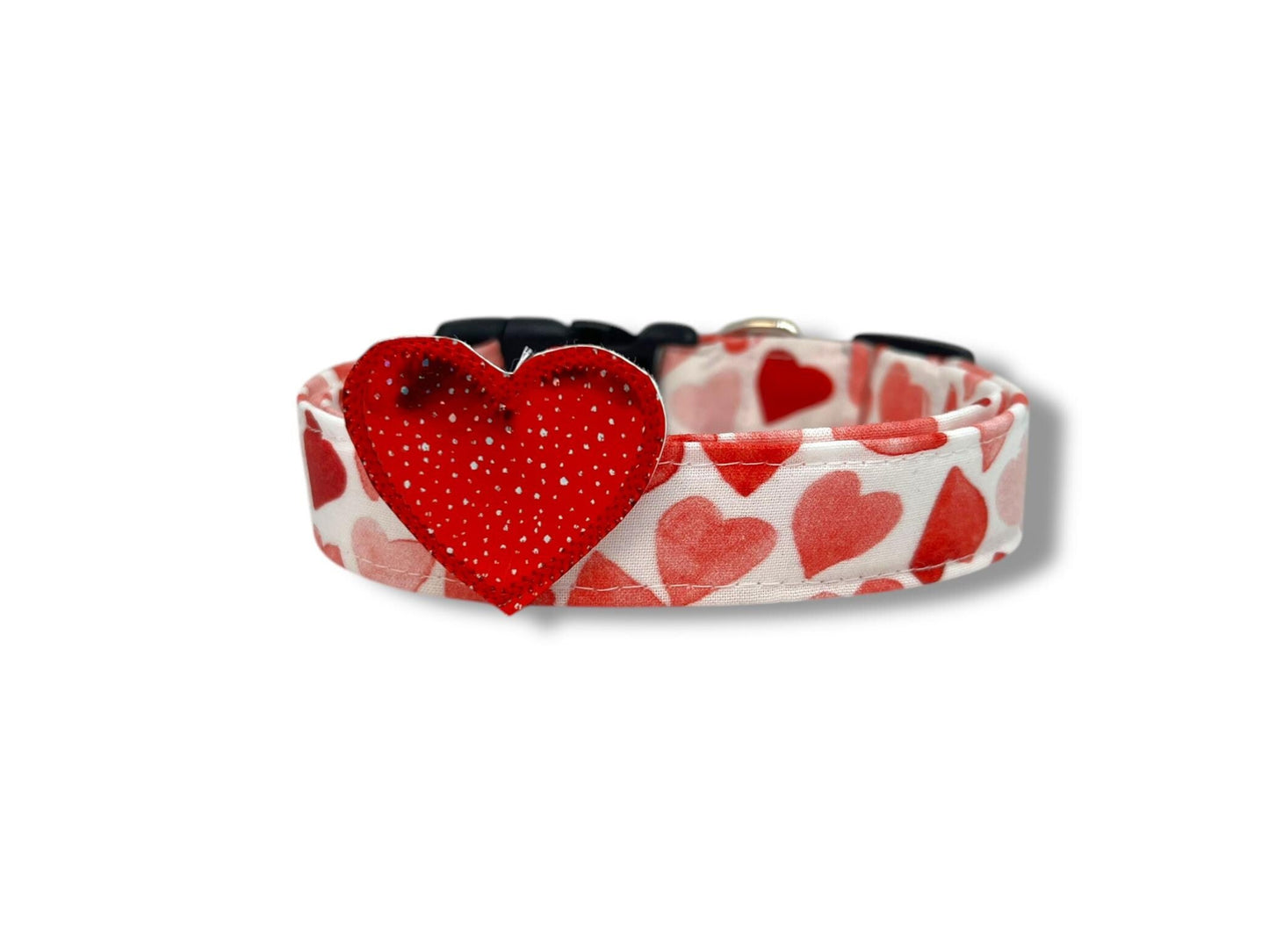Dog collar with red heart design on a white background with speckled red heart embellishment 