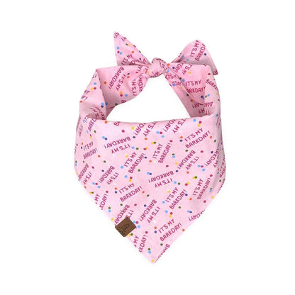 Pink dog bandana with "It's My Barkday" print and confetti accents for a birthday celebration.