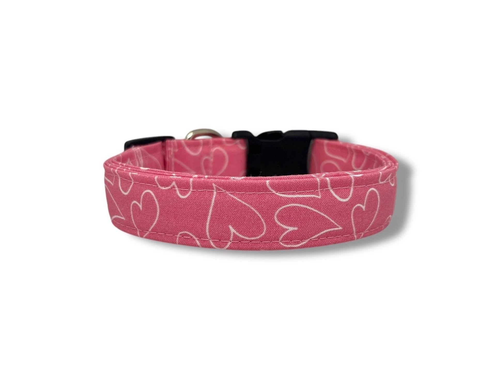 Bright pink dog collar with white heart outline design, Valentine’s Day themed dog collar shown flat and ready to wear.