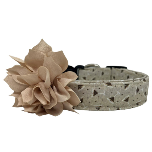 Beige dog collar featuring a playful espresso martini-themed print with tiny martini glasses and coffee beans, with dog collar flower embellishment, laid flat on a white background