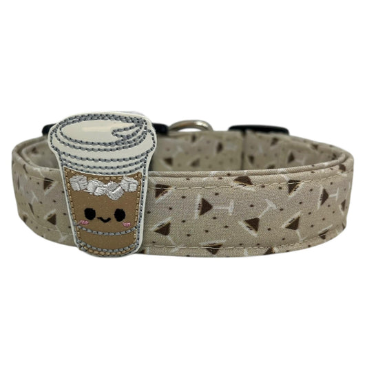 Beige dog collar featuring a playful espresso martini-themed print with tiny martini glasses, coffee beans and an iced coffee cup embellishment, laid flat on a white background.
