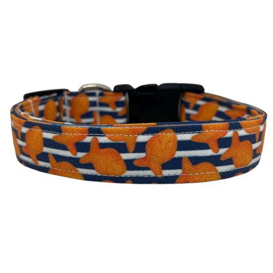 Navy and white striped dog collar with vibrant orange goldfish printed throughout, displayed flat on a white background for a nautical, playful look.
