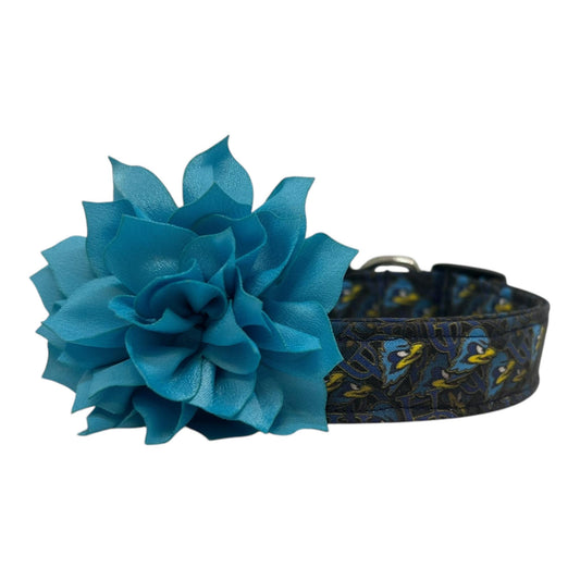 Navy blue dog collar featuring the University of Delaware UD logo and Blue Hens graphics with turquoise dog collar flower, laid flat on a white background.