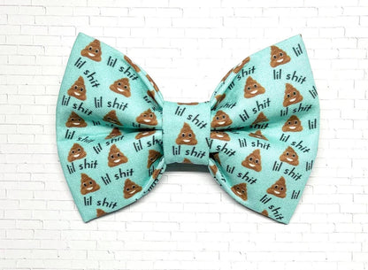 Aqua dog bow tie with the phrase “Lil Shit” and playful poop emojis, designed for pups with big attitudes and a sense of humor.