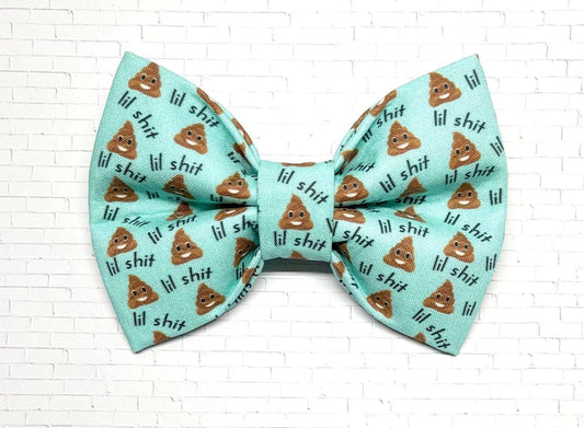 Aqua dog bow tie with the phrase “Lil Shit” and playful poop emojis, designed for pups with big attitudes and a sense of humor.