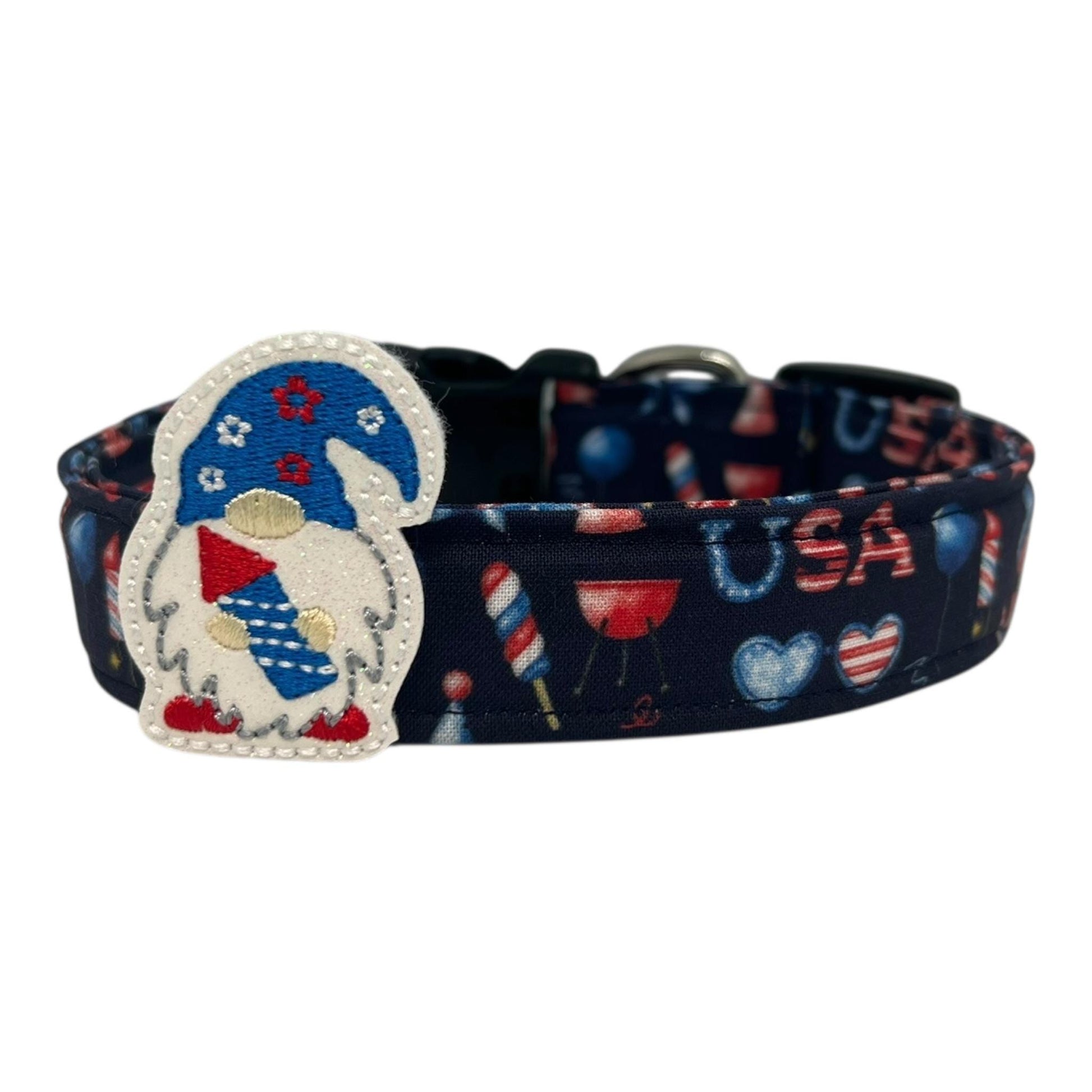 Navy blue 4th of July dog collar decorated with red, white, and blue icons like popsicles, BBQ grills, fireworks, and balloons, featuring a whimsical gnome holding a firecracker embellishment.