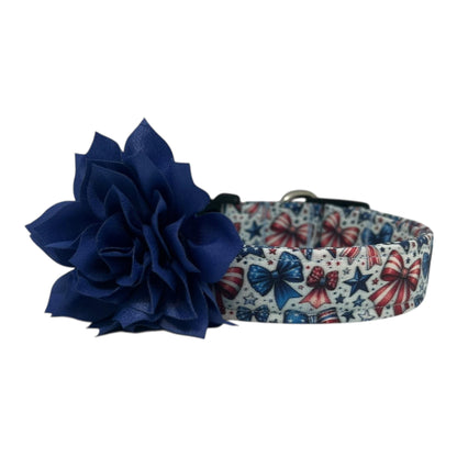 Patriotic dog collar with red, white, and blue bows and stars on a light background, shown with a detachable flower accessory in the color of your choice.