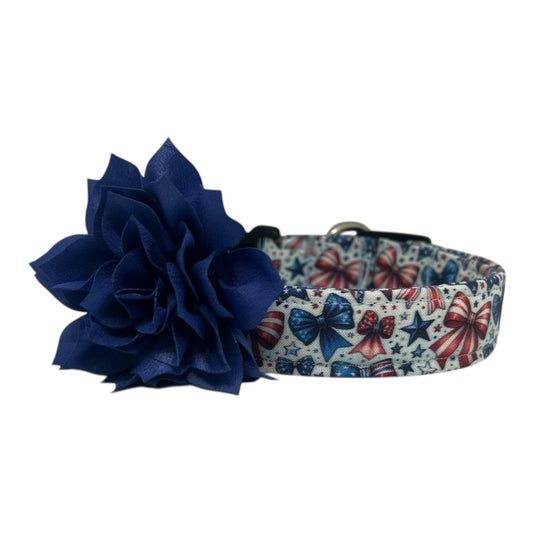 Patriotic dog collar with red, white, and blue bows and stars on a light background, shown with a detachable flower accessory in the color of your choice.