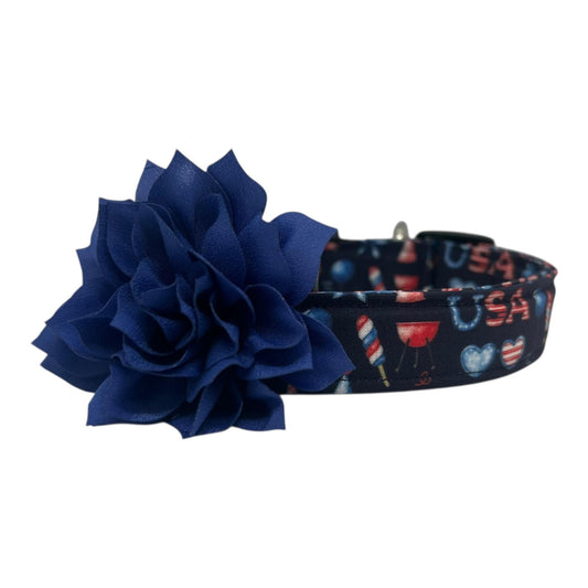 Navy blue 4th of July dog collar featuring red, white, and blue icons like popsicles, BBQ grills, fireworks, and balloons, paired with a detachable 3" or 4" flower in your choice of color.