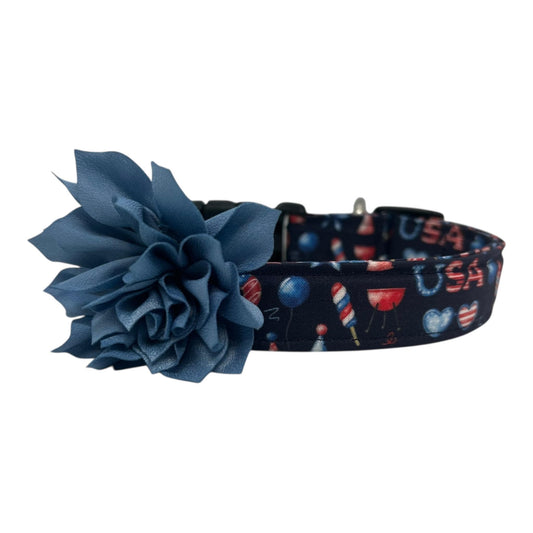 Navy blue 4th of July dog collar featuring red, white, and blue icons like popsicles, BBQ grills, fireworks, and balloons, paired with a detachable 3" or 4" flower in your choice of color.