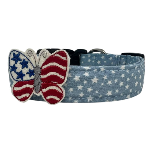 Light blue chambray dog collar with scattered white stars, paired with a removable red, white, and blue patriotic butterfly embellishment.

