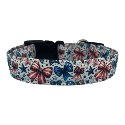 Patriotic dog collar with red, white, and blue bows and stars on a light background.