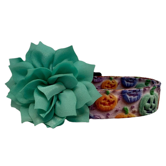 Halloween dog collar with rainbow jack-o’-lanterns in orange, green, purple, and blue with aqua removable dog collar flower. 