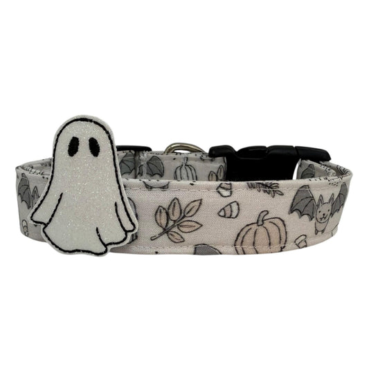 Dog collar with Halloween-themed design featuring ghosts, pumpkins, and bats on a white background.