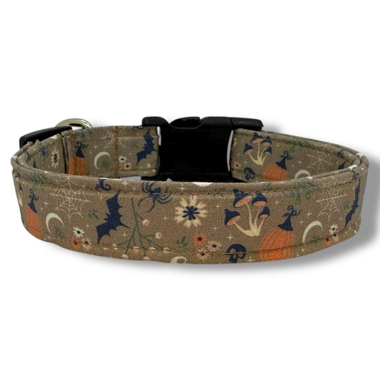Halloween dog collar with pumpkins, bats, spiders, mushrooms, flowers, leaves, spider webs, and skulls in cozy cottagecore fall style.