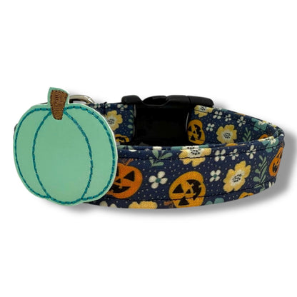 Halloween dog collar with jack-o’-lanterns, floral accents, and removable aqua pumpkin embellishment on a navy blue background.